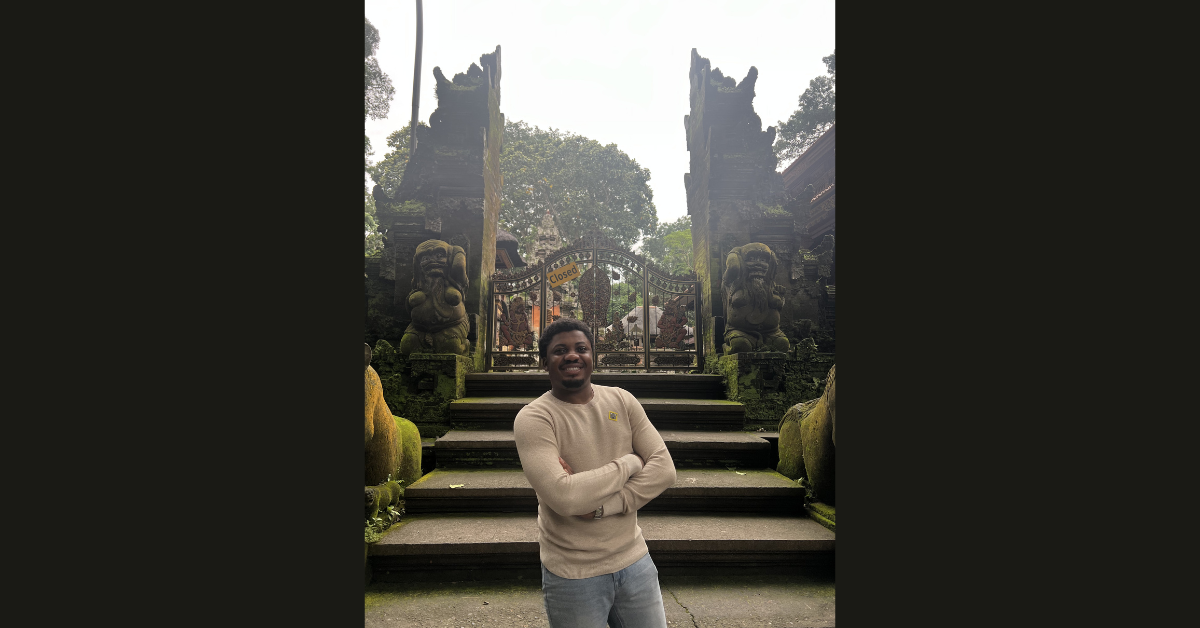 Yakubu Adam posing by a gate